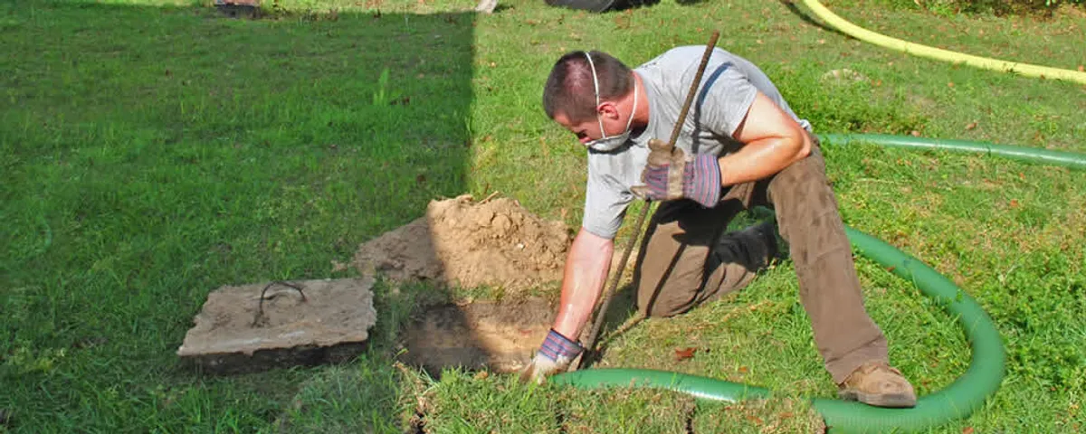 Septic pumping technician servicing a residential septic tank in Orange, CA